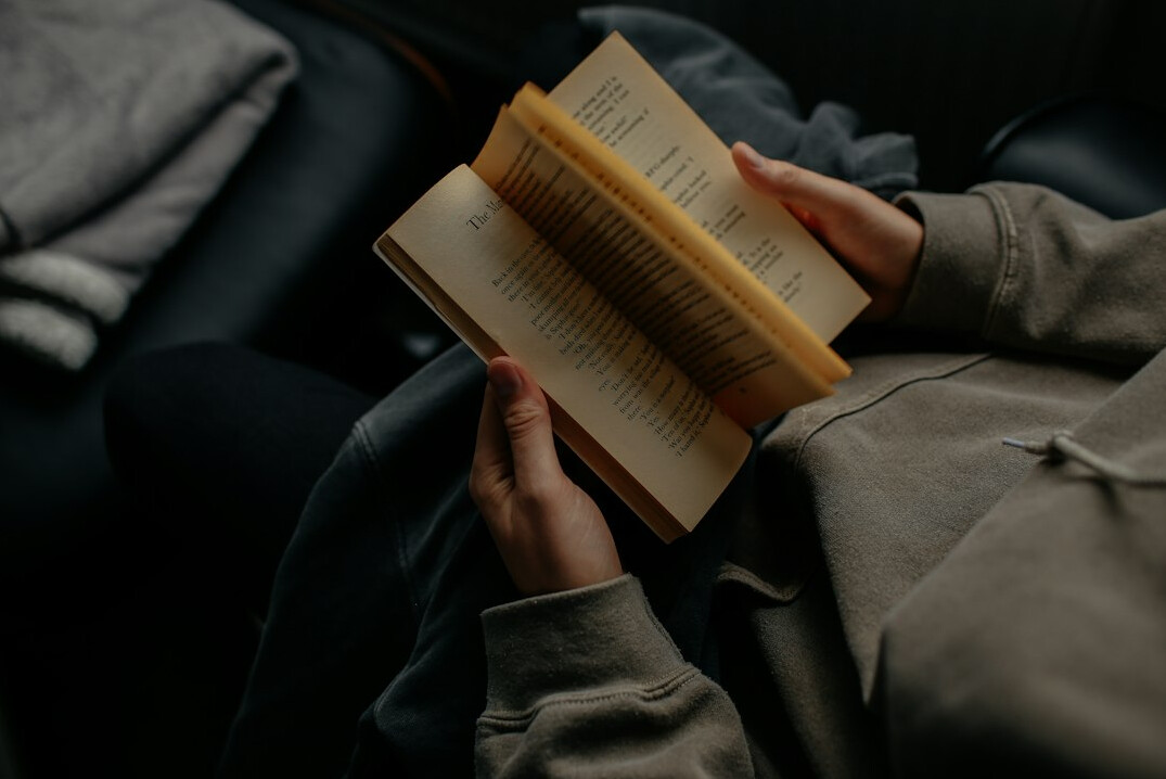 person reading book at night